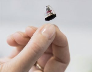 Invisible hearing aid in hand
